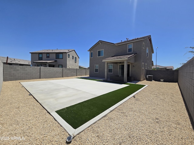 back of property with a patio, central AC, a fenced backyard, and stucco siding