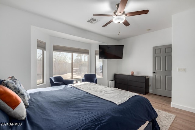 bedroom with radiator, ceiling fan, and light hardwood / wood-style flooring