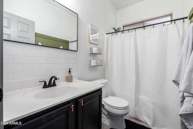 bathroom featuring backsplash, curtained shower, vanity, and toilet