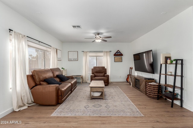 living room featuring ceiling fan and light hardwood / wood-style flooring