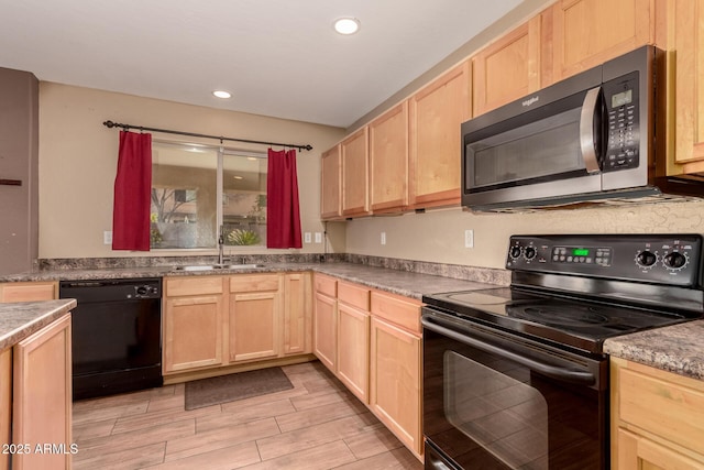 kitchen featuring sink, light brown cabinets, and black appliances