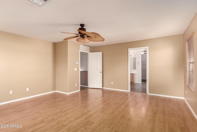 spare room with light wood-type flooring and ceiling fan