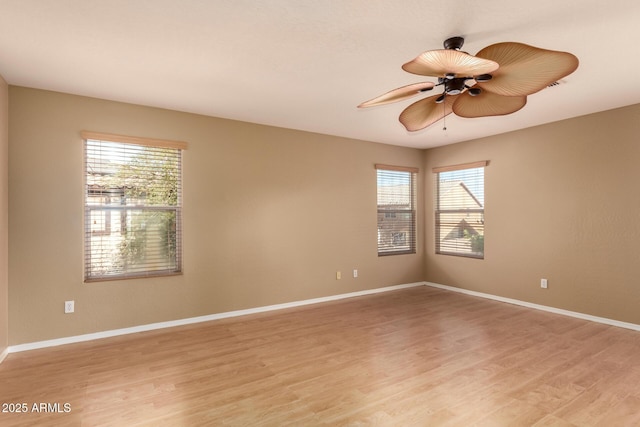 unfurnished room featuring light hardwood / wood-style floors, ceiling fan, and a healthy amount of sunlight