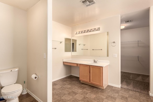 bathroom featuring toilet and vanity