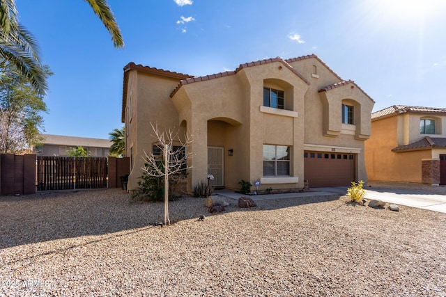 mediterranean / spanish-style home with a garage