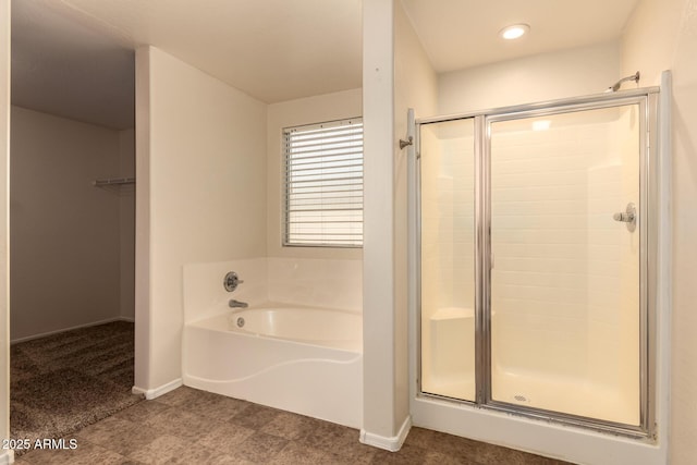 bathroom featuring separate shower and tub