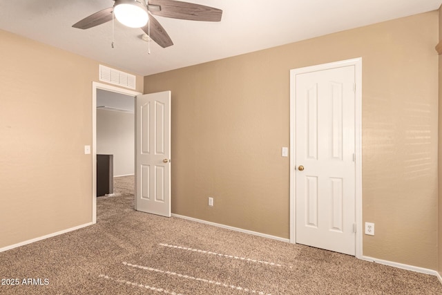 unfurnished bedroom featuring ceiling fan and carpet