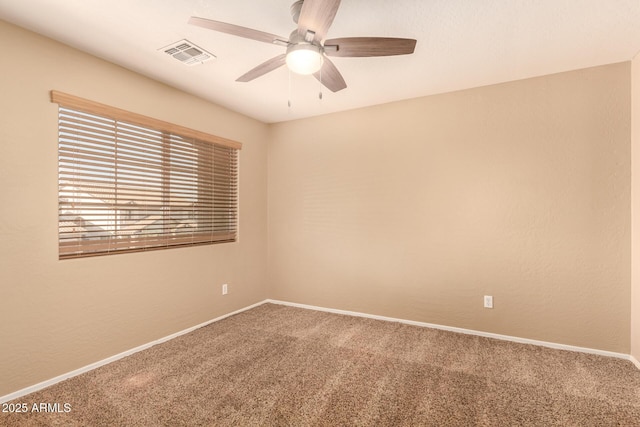 spare room with ceiling fan and carpet flooring