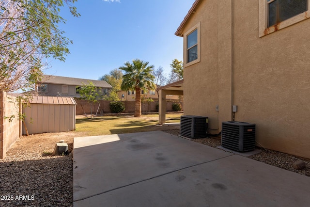 view of patio with a shed and central air condition unit