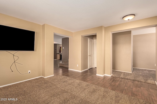 unfurnished bedroom featuring dark carpet and a closet