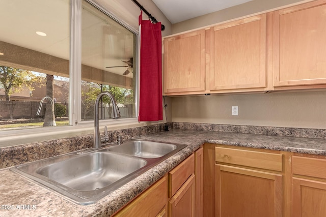 kitchen featuring ceiling fan and sink