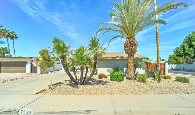 7524 N Via Del Elemental, Scottsdale, AZ 85258 - view of front of house featuring driveway, a garage, and stucco siding
