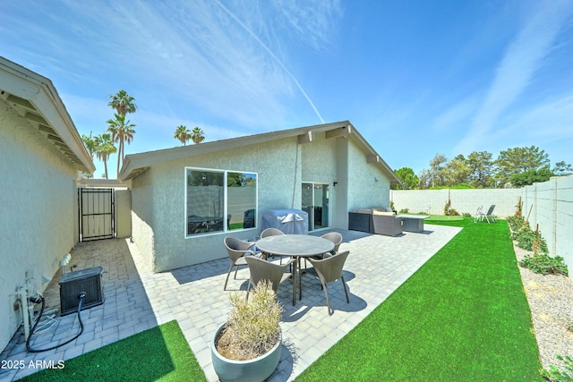 7524 N Via Del Elemental, Scottsdale, AZ 85258 - back of property featuring stucco siding, a gate, a patio, and outdoor lounge area