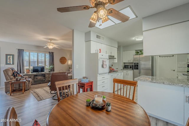 dining area featuring ceiling fan and light hardwood / wood-style floors