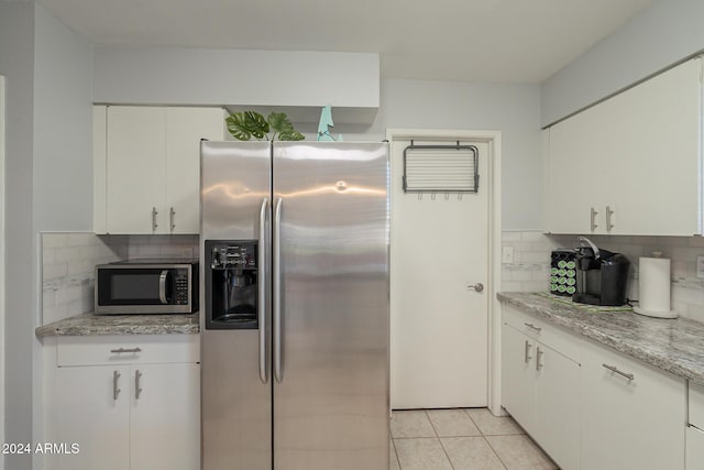 kitchen featuring stainless steel appliances and white cabinetry