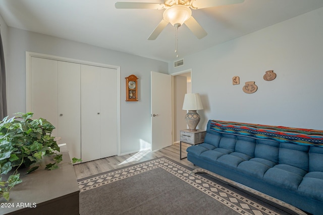 living room with wood-type flooring and ceiling fan