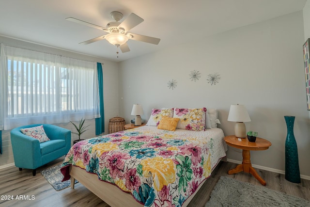 bedroom with ceiling fan and wood-type flooring