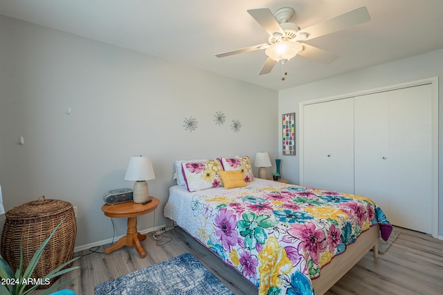 bedroom with wood-type flooring, a closet, and ceiling fan