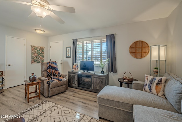 living room with ceiling fan and light wood-type flooring