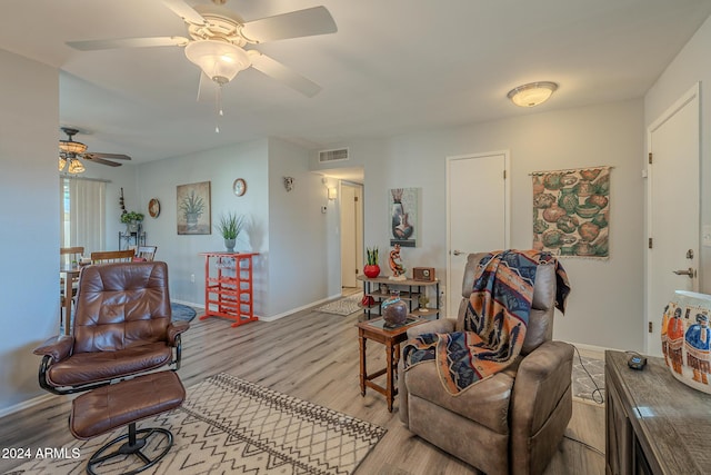 living room with light hardwood / wood-style floors and ceiling fan