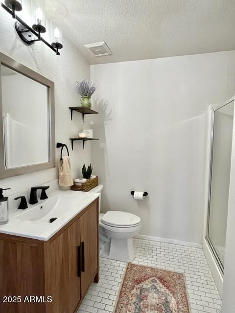 10229 N 12th Ct Unit 1, Phoenix, AZ 85020 - full bath featuring toilet, a shower stall, tile patterned floors, a textured ceiling, and vanity