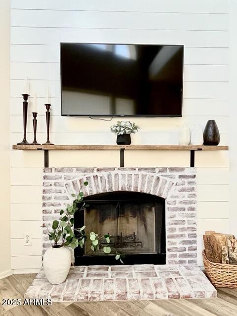 10229 N 12th Ct Unit 1, Phoenix, AZ 85020 - detailed view of a fireplace, wood finished floors, and wooden walls
