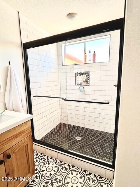 10229 N 12th Ct Unit 1, Phoenix, AZ 85020 - full bath with a shower stall, vanity, a textured ceiling, and tile patterned flooring