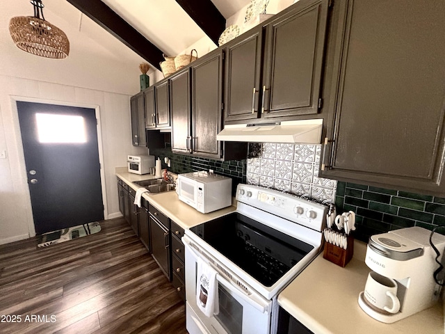 251 W 8th St, Ajo, AZ 85321 - kitchen featuring white appliances, under cabinet range hood, dark wood-style floors, light countertops, and tasteful backsplash