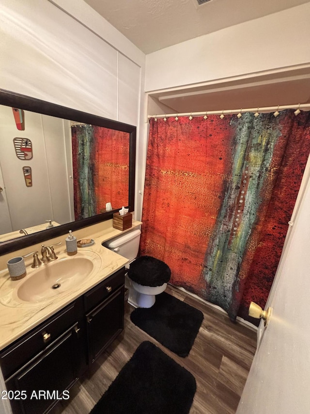 251 W 8th St, Ajo, AZ 85321 - bathroom featuring vanity, wood finished floors, toilet, and a shower with curtain