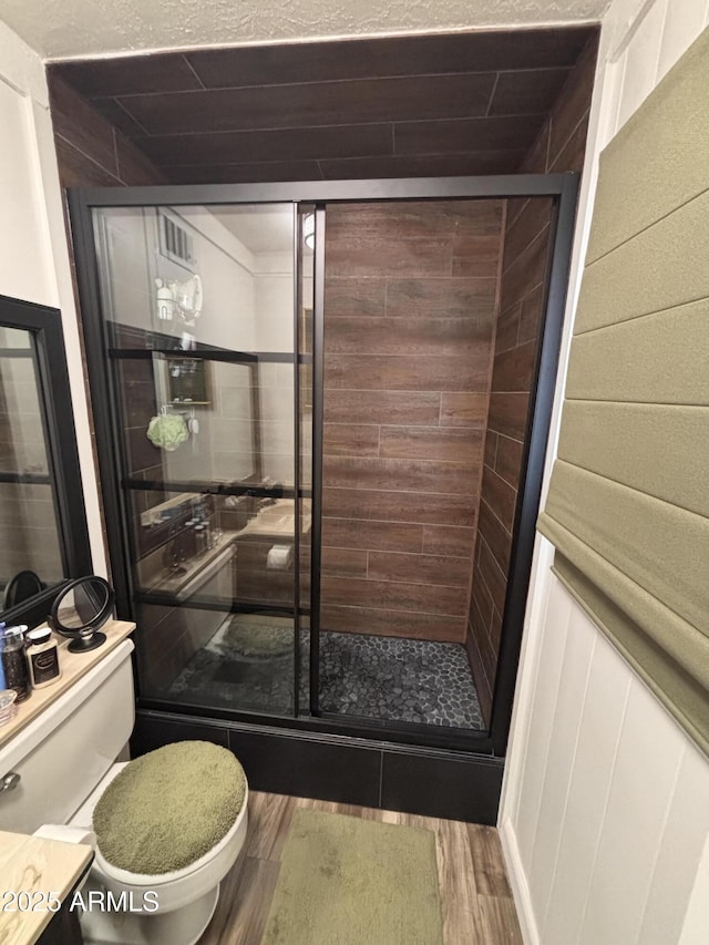 251 W 8th St, Ajo, AZ 85321 - full bath featuring toilet, a stall shower, and wood finished floors