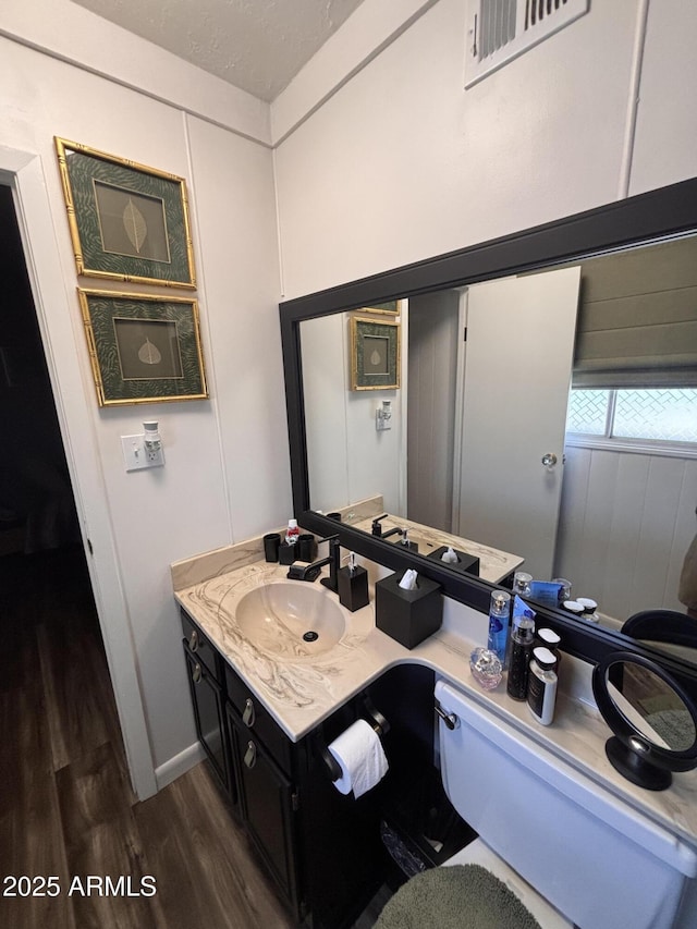 251 W 8th St, Ajo, AZ 85321 - bathroom featuring wood finished floors and vanity