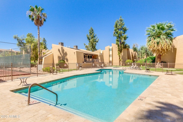 community pool featuring a patio area and fence