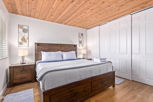 bedroom with light wood-type flooring, a closet, and wood ceiling