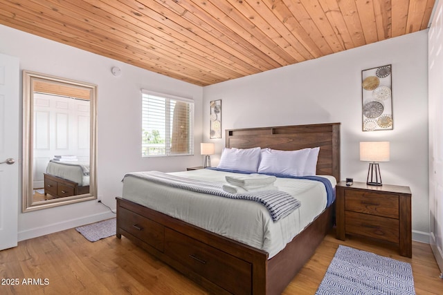 bedroom featuring baseboards, light wood-type flooring, and wood ceiling