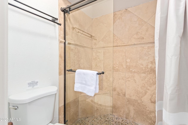full bath with toilet and a stall shower