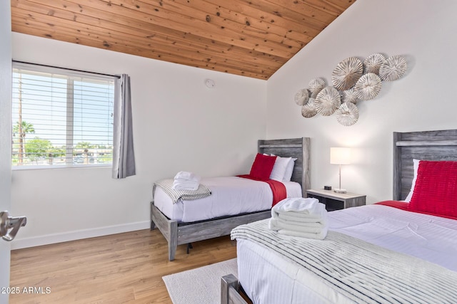 bedroom with wooden ceiling, wood finished floors, baseboards, and lofted ceiling