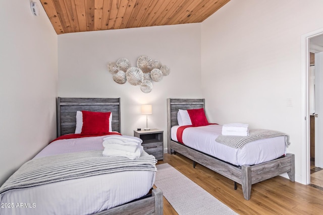 bedroom featuring vaulted ceiling and wood finished floors
