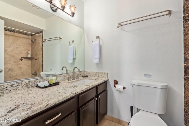 full bath with toilet, vanity, and a shower