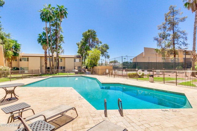 pool featuring a patio area and fence