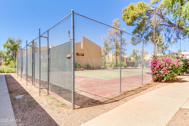 view of sport court featuring fence