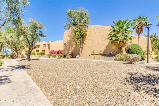 pueblo revival-style home with stucco siding
