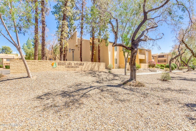 view of side of home with fence and stucco siding