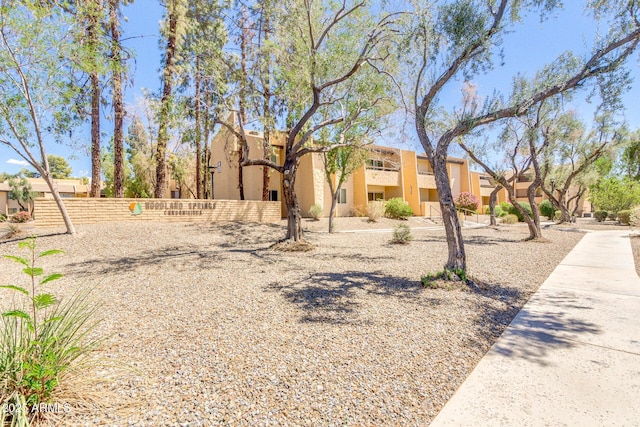 exterior space featuring stucco siding and fence