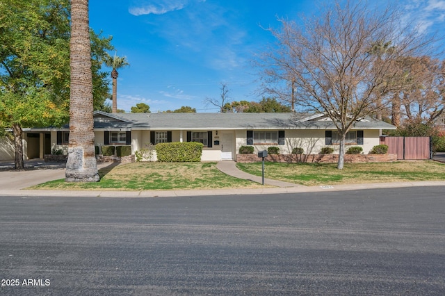 single story home featuring a front lawn