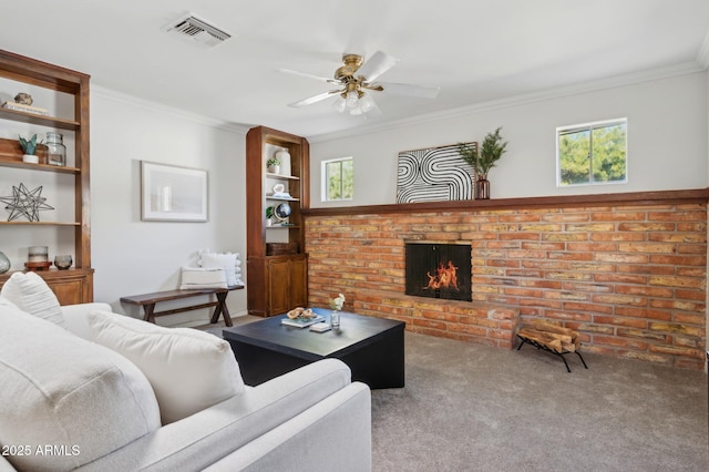 living room with a fireplace, ornamental molding, ceiling fan, and carpet flooring