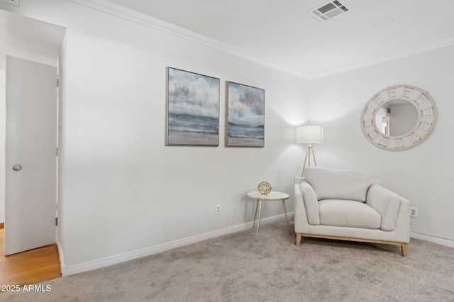 sitting room with light colored carpet and ornamental molding