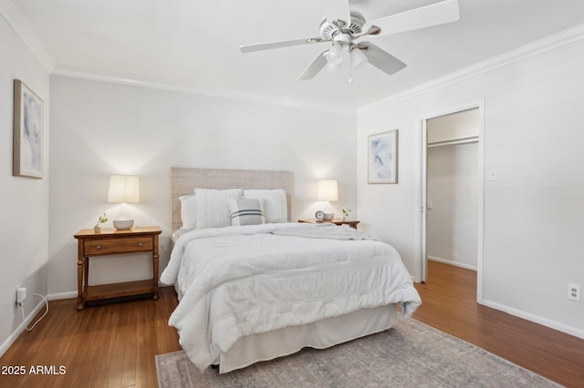 bedroom with wood-type flooring, ornamental molding, and ceiling fan