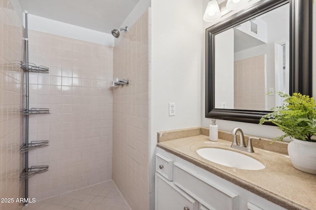 bathroom featuring vanity and a tile shower