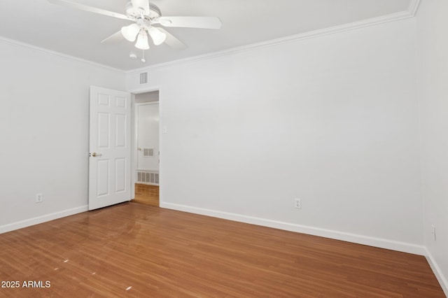 empty room with hardwood / wood-style flooring, ceiling fan, and ornamental molding