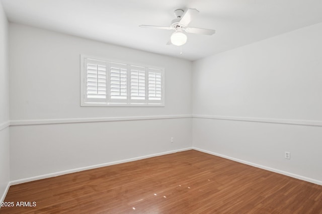 spare room with hardwood / wood-style flooring and ceiling fan